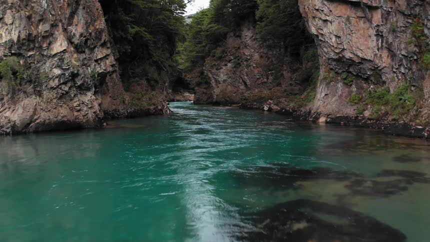 Aerial shot revealing an untouched and pristine glacial fed river deep in the Patagonia wilderness
