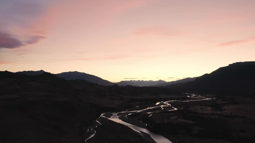 A brilliant sunset reflects golden light from a meandering river in the wilds of Parque Patagonia in Chile