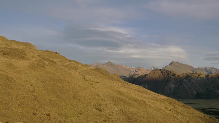 Lenticular clouds dance as shadows creep across landscape as time passes in pristine Patagonia