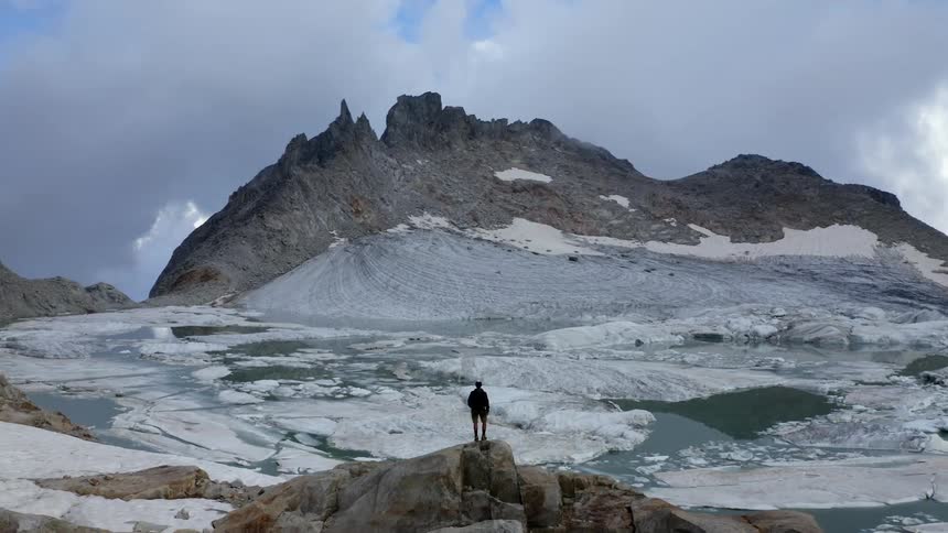 A person is standing on the mountains