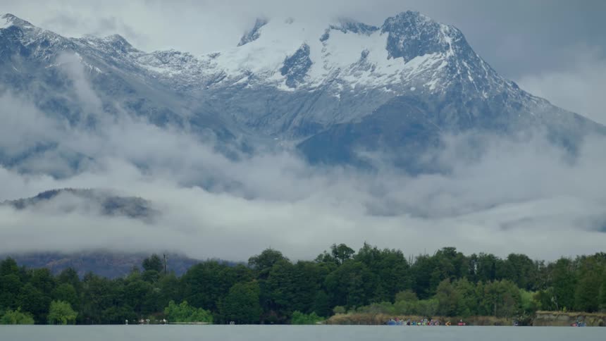 Low hanging clouds hang low in a deep river valley in this solemn and broody shot
