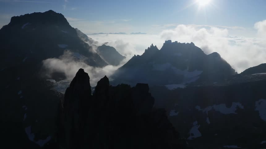 Dense fog settles in the valley between mountains