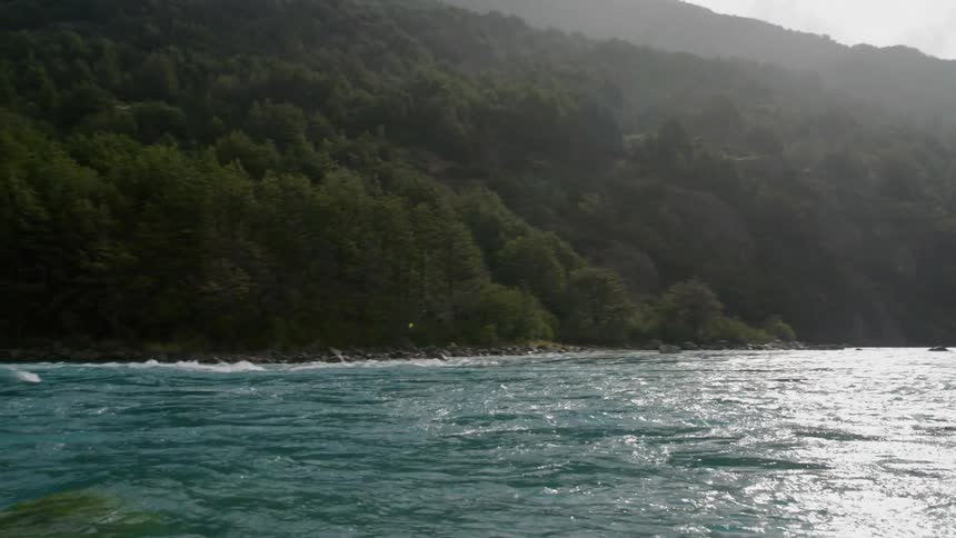 Gentle waves and current glides in this pristine river deep in rural Patagonia in South America