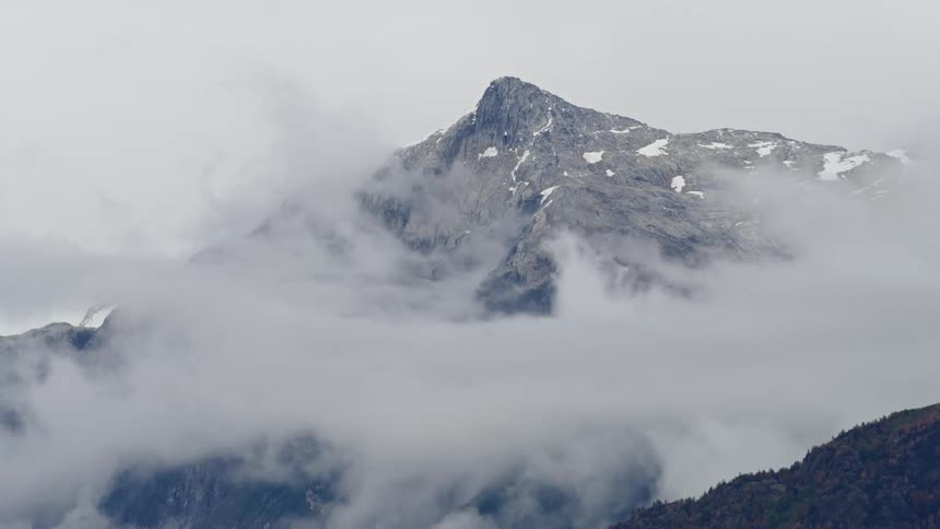 Time lapse of clouds and fog billowing and swirling around a Andean mountain peak deep in Patagonia, home of dynamic and ever changing weather