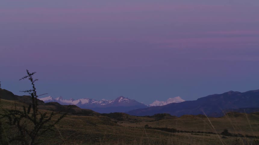 Blue hour slow pan revealing the epic beauty of glacier covered peaks