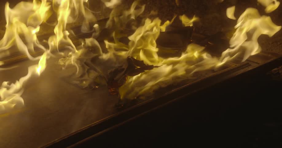 Fire burning a wooden object in the night