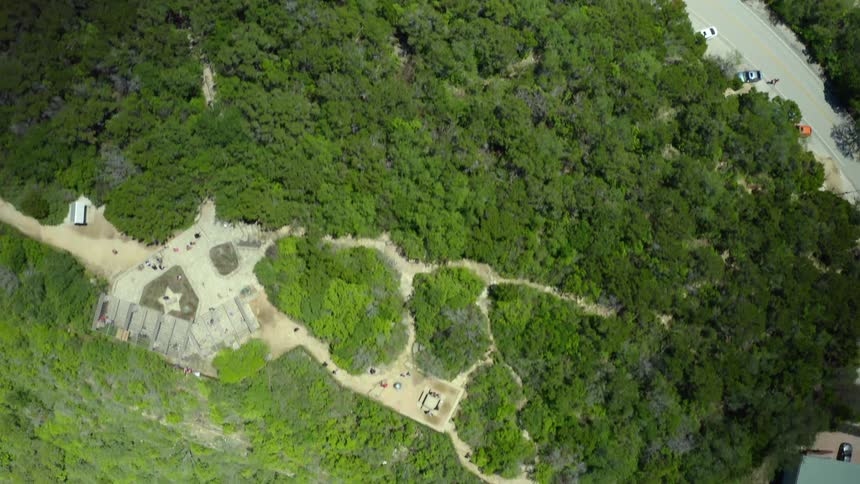 An aerial view of a mountain range with trees on it