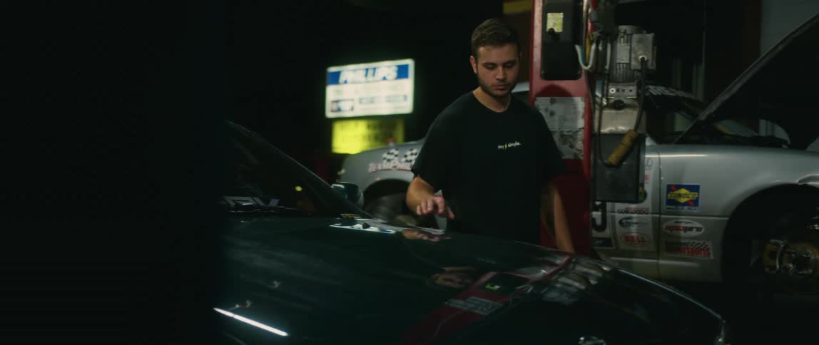 A man walking around in an automotive shop