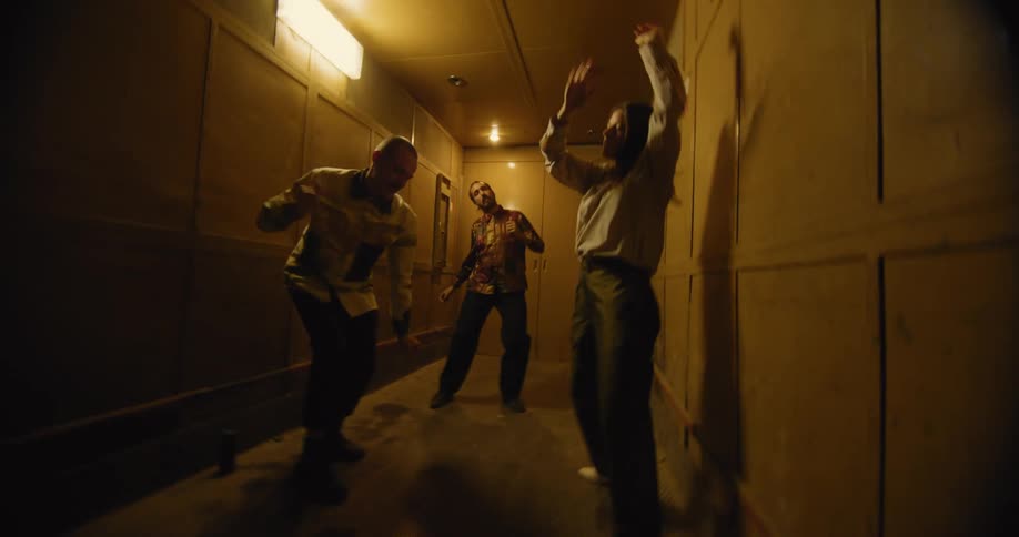 Three people dancing in a hallway