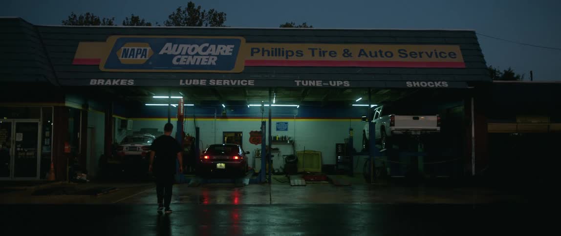 A man walking into an automotive shop