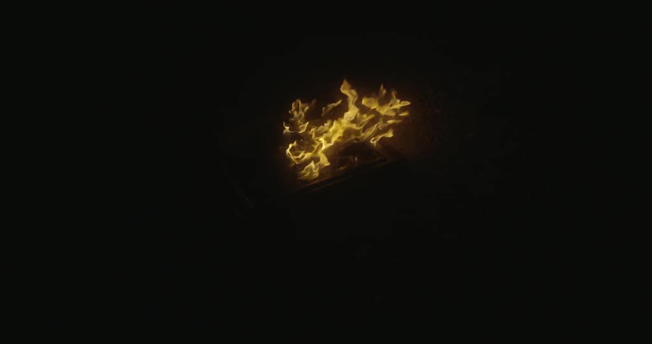 A fire burning in a dark area