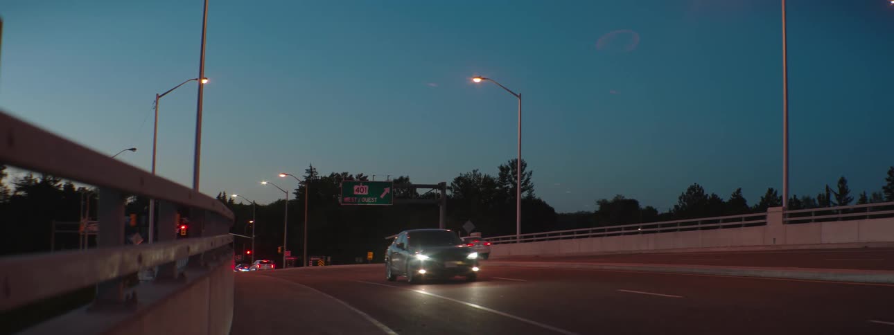 A view of cars driving down a road at dusk