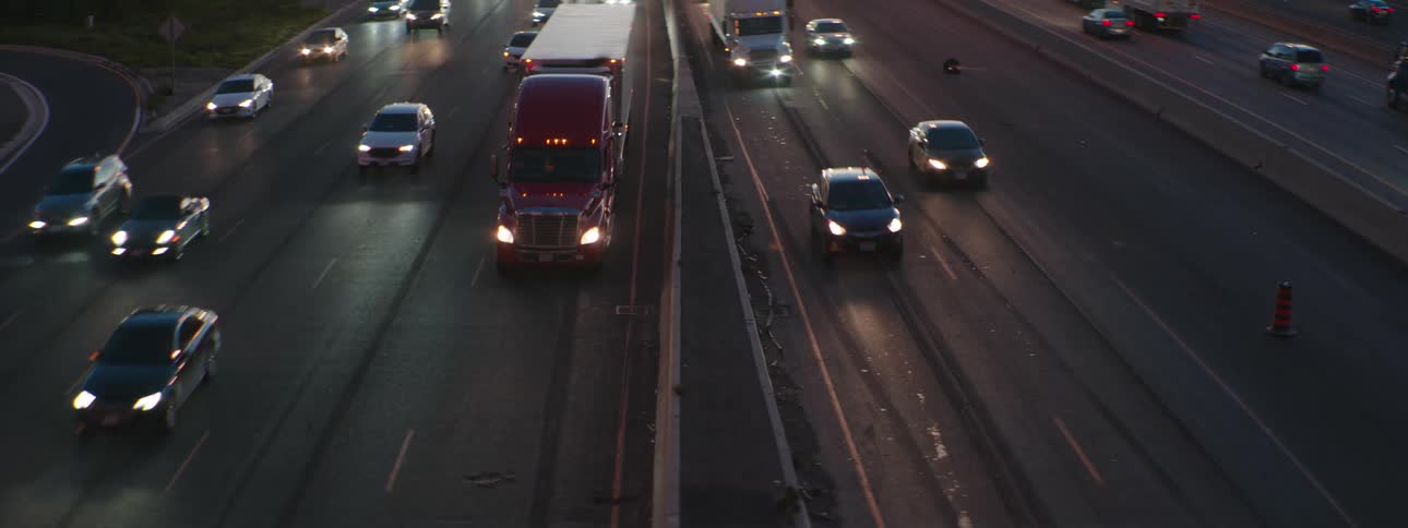 A view of cars and trucks driving down the highway