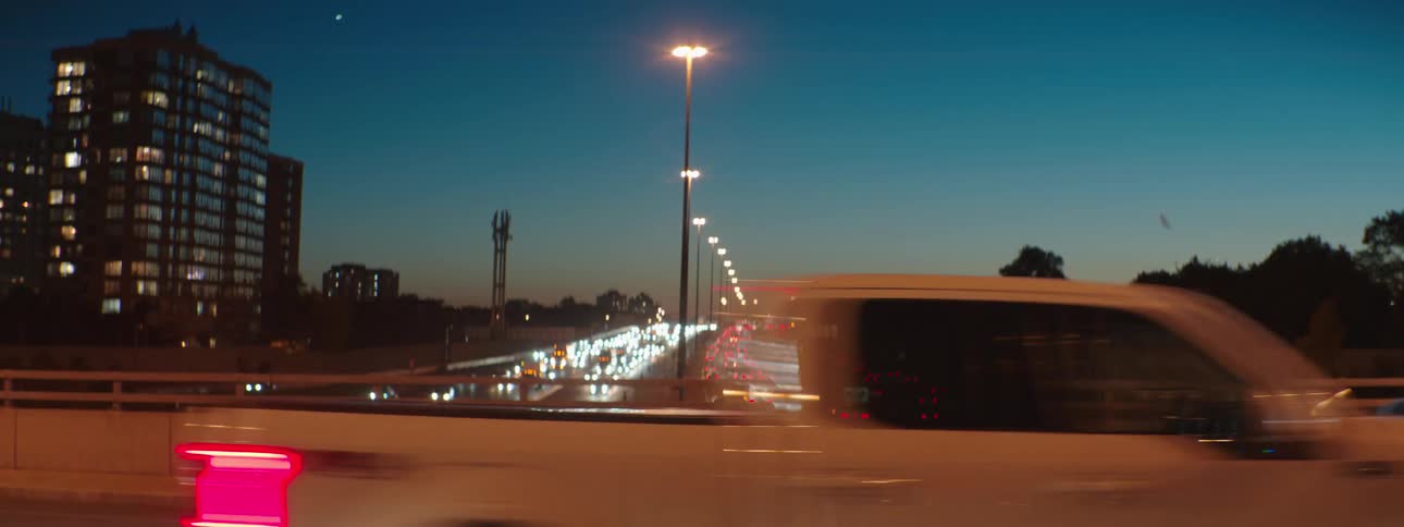 Cars travel on an overpass above traffic on a highway