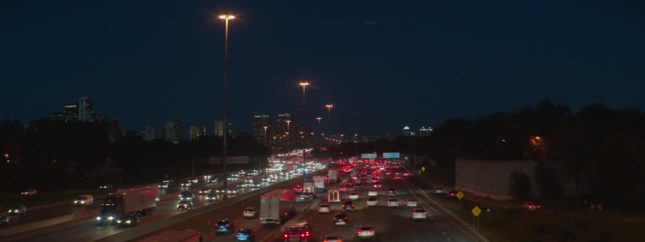 Bumper to bumper traffic heads in and out of downtown on a multi lane highway