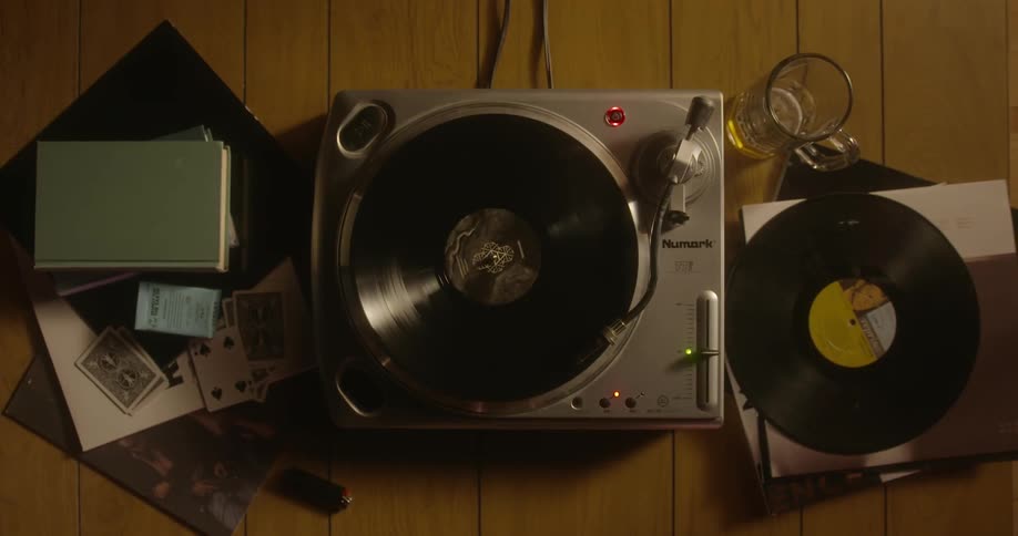 A person places a record on a player