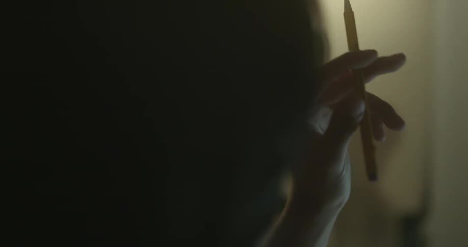 A person is tapping a pencil between their fingers