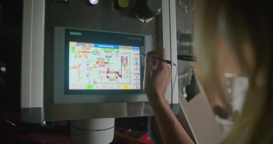 A woman is using a stylus to operate a machine