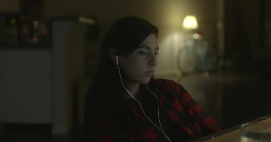 Young woman listening to headphones while seated