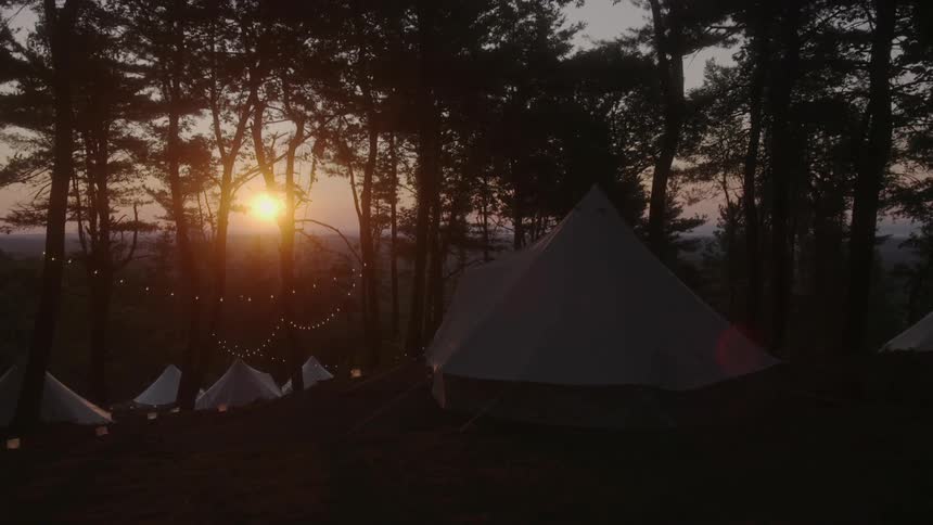 The sun is setting behind this camp site