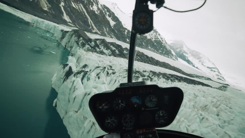 A helicopter flying around glaciers