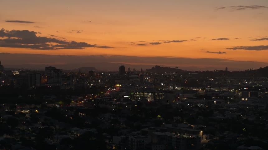 Aerial view of the night lights of a small city skyline at sunset
