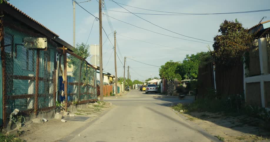 Man riding a motorcycle on a single tire on the neighborhood street