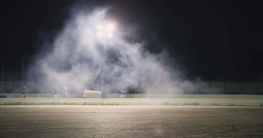 Motorcycle driving on a race track at night