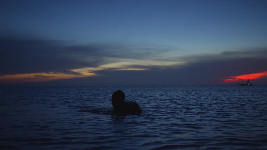 A person moves under the water of the ocean