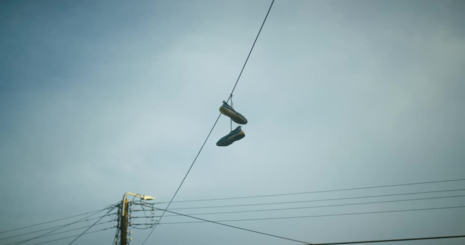 Sneakers are hanging from the power line