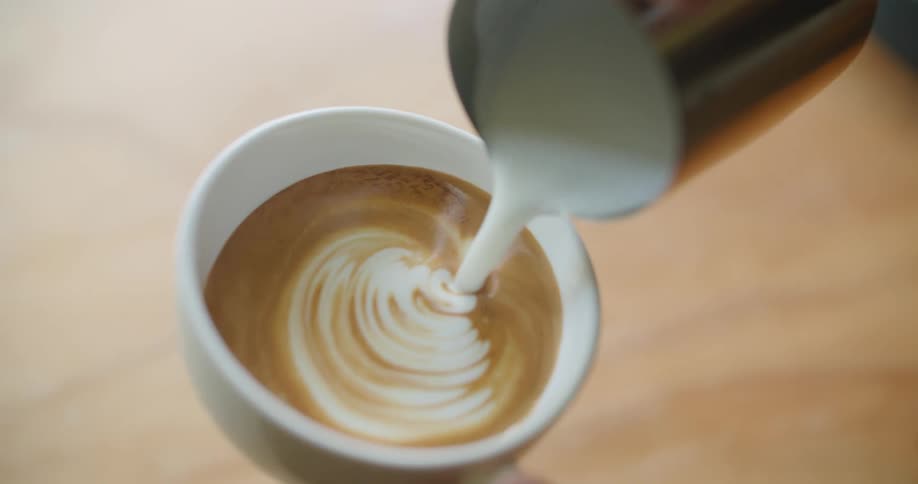 Cream is poured into the drink