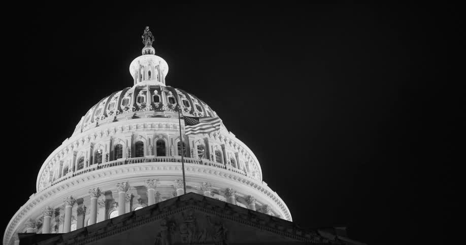 A static shot of a capitol building with a flag