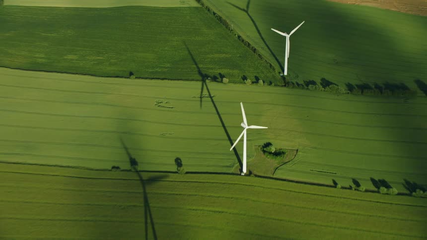 The farm land is covered with windmills