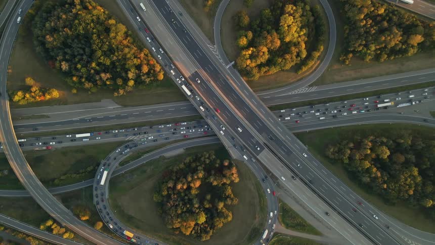 Top down aerial view of vehicles driving on a highway at morning