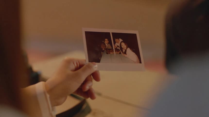 Friends looking at a recently taken polaroid picture of themselves