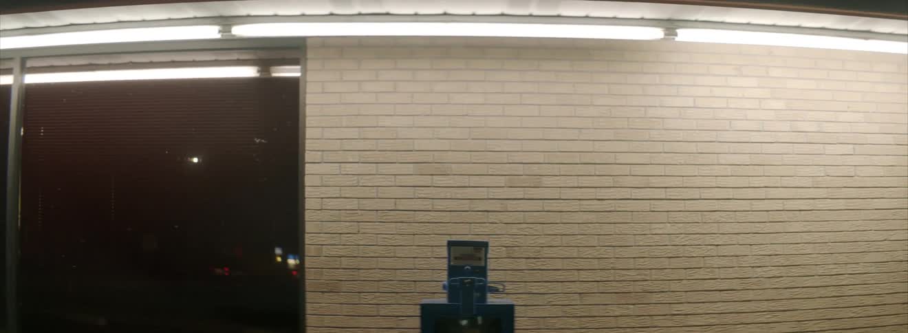 A newspaper vending machine in front of a building