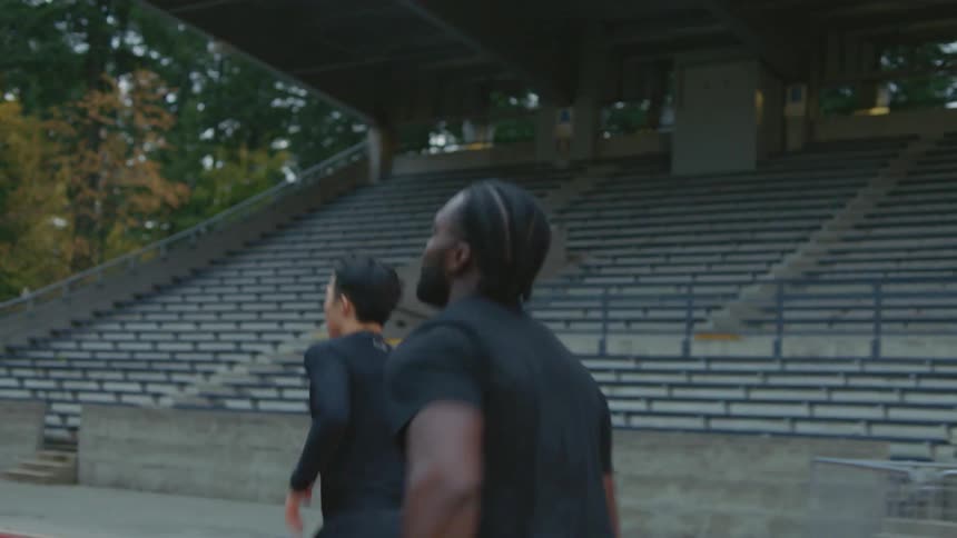 As two men jog on the track one begins running