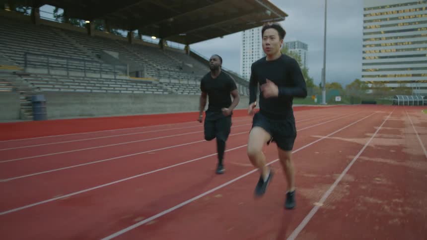 Two men race on the running track