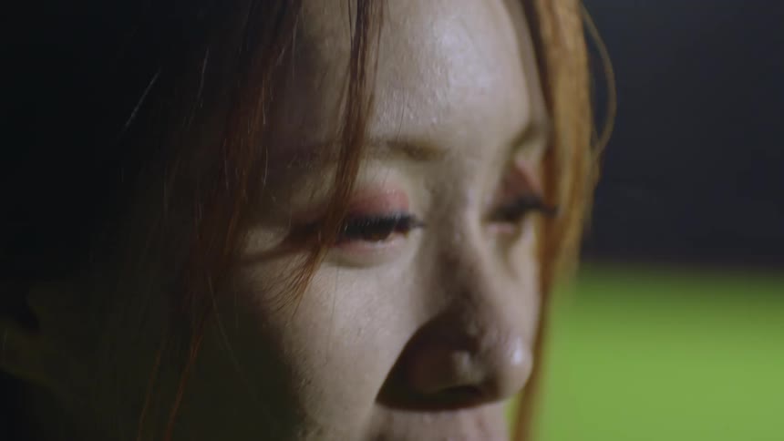 A woman is breathing heavy while smiling