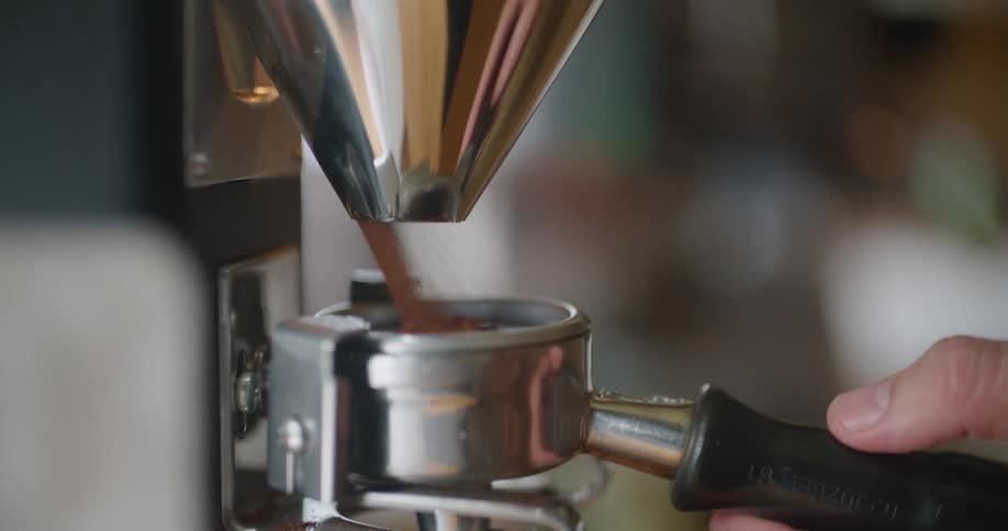 A machine fills the handle with ground coffee