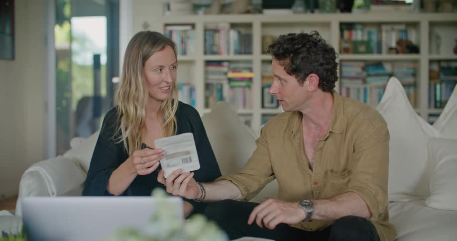 A man and woman read a pamphlet together and talk