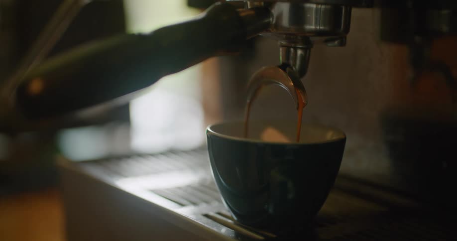 A cappuccino machine fills the mug