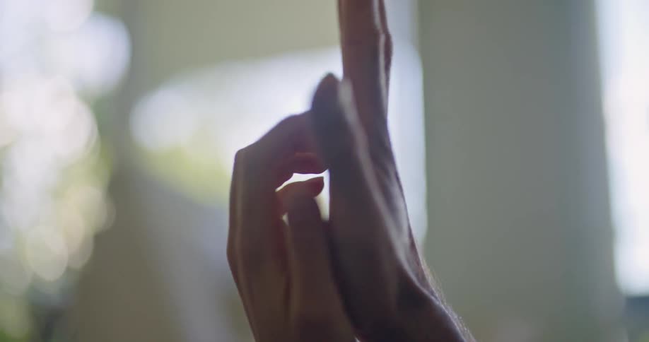 Two people hold hands intertwining their fingers
