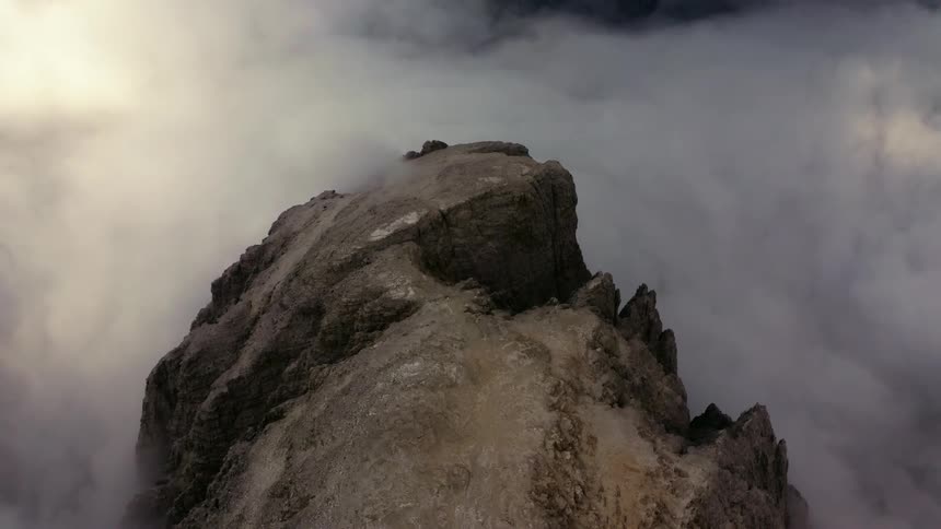 Mountain peak high in the sky above the clouds