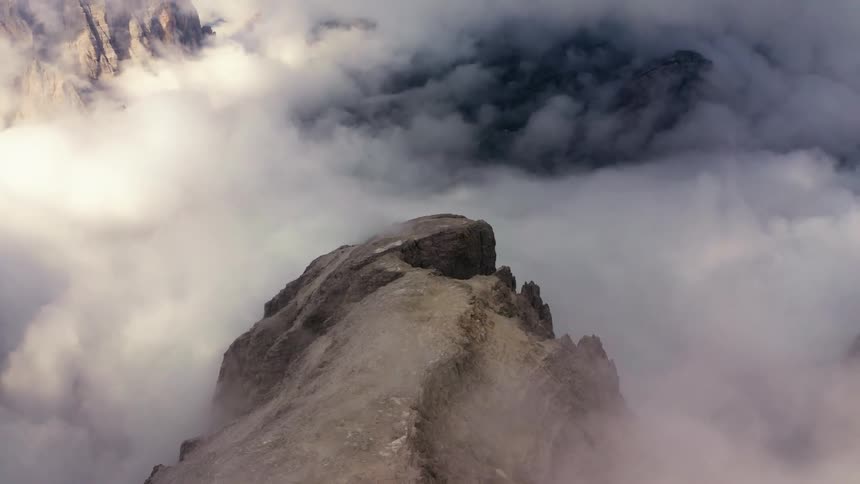 Aerial view mountain peak over the white clouds at morning
