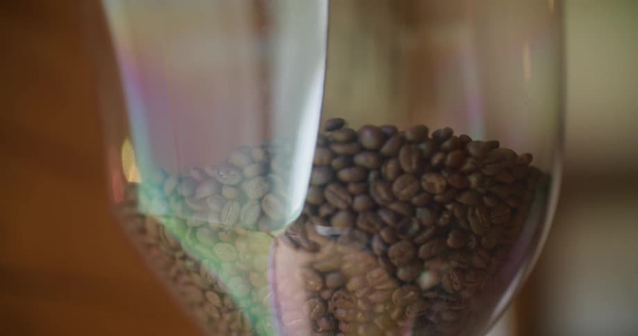 A view of coffee beans filling up a cup