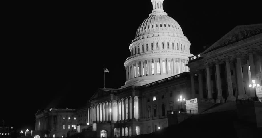 The capitol building at night with the lights on