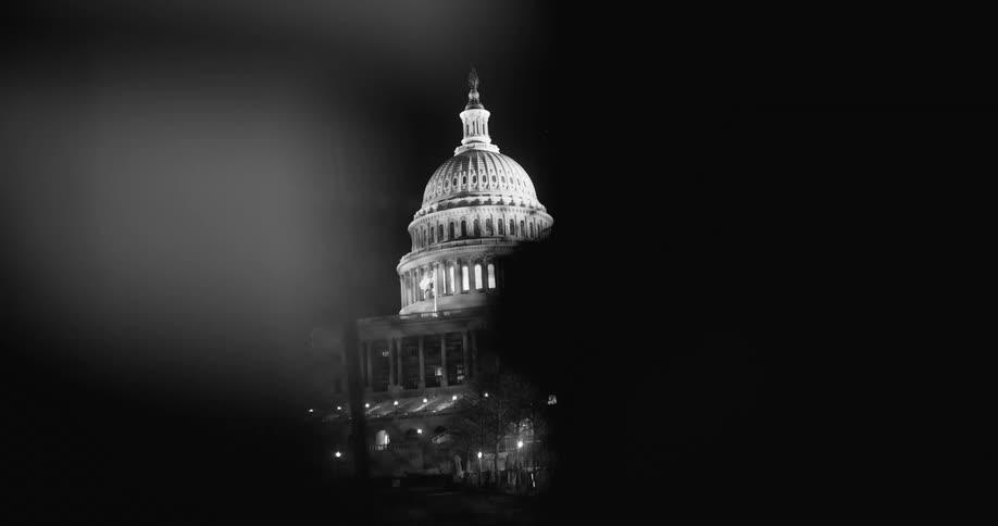 The capitol building at night with the lights on