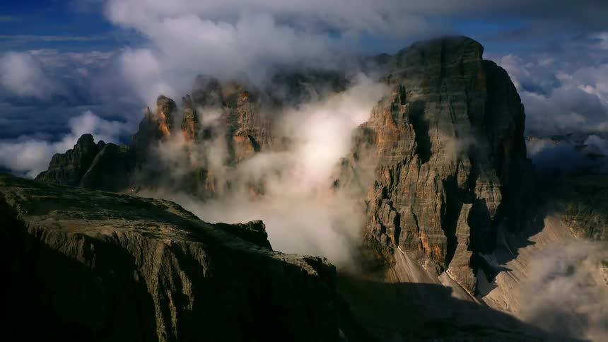 Mountain ridge high in the sky among the clouds