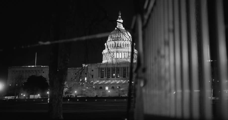 The capitol building at night with the lights on